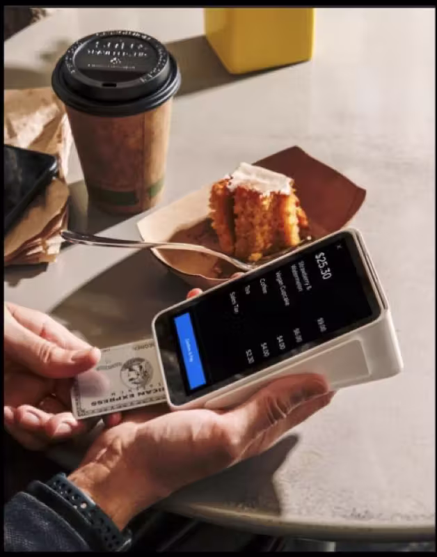 Cafe POS terminal next to coffee and pastry